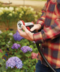 Heavy Duty Garden Hose Nozzle With Five Adjustable Spray Patterns For Lawn And Garden in use, focusing on ergonomic grip