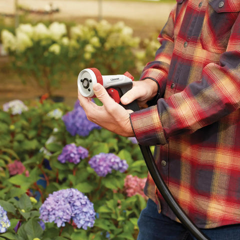 Heavy Duty Garden Hose Nozzle With Five Adjustable Spray Patterns For Lawn And Garden in use, focusing on ergonomic grip