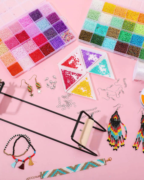 All In One Bead Loom Kit With 24000 Glass Seed Beads In 48 Colors For Adults Dope Jewelry Making Supplies For Bracelets Earrings And Christmas Gifts Diy Craft displayed on a pink background with accessories and finished jewelry pieces.