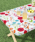 Floral 30x72 Inch Rectangle Vinyl Tablecloth With Elastic Edge Snug Fit No Slip Flannel Backing Fitted 6 Foot Table Cover For Picnic Camping And Outdoor Use Waterproof And Stain Resistant Plastic Table Cloth displayed on outdoor table with drinks and fruit.