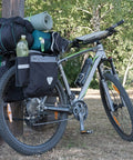 Bicycle loaded with camping gear secured by Ultimate Flat Outdoor Bungee Cord Set, 28 Heavy Duty Cords In 18, 24, 32, And 40 Inch Lengths