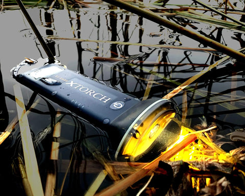 Rechargeable Solar Powered Flashlight Lantern for Camping and Outdoors USB and Solar Charging in water, showing durability