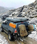 SUV with Portable 5 Gallon Military Style Water Jug For Camping And RVs on a snowy trail