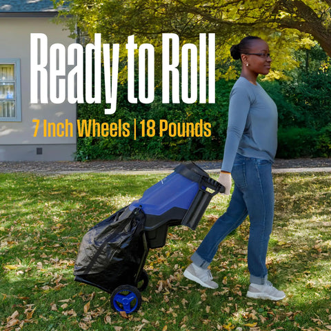 Person using Corded Electric Wood Chipper Shredder Be The Yard Boss With 1.7 Inch Capacity And 15 Amp Motor.