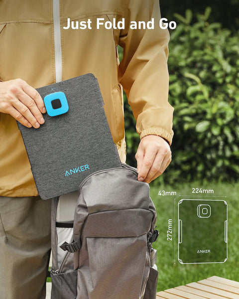 Person placing Solix PS30 Foldable 30W Solar Panel Charger in backpack, showing compact size and ease of use for camping.