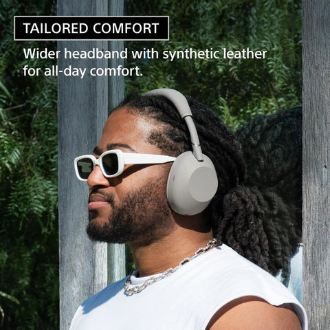 Man wearing Top Tier Noise Canceling Wireless Headphones With HD NC Processor QN3, white synthetic leather headband, outdoors