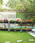 32 Inch Tall Elevated Raised Garden Bed With Trellis And Sturdy Legs For Vertical Outdoor Gardening Of Vegetables Herbs And Flowers In Four Separate Planter Boxes For Balcony Patio Or Backyard Black, displaying colorful flowers