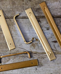 Two Pack Antique Brass Cabinet Pulls With Backplates Vintage Drawer Handles on wooden background
