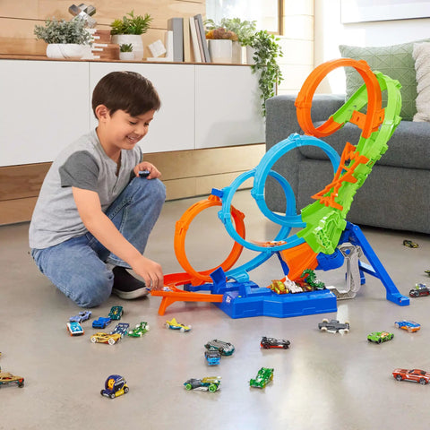 Child playing with Four Loop Track Set With Three Way Crash Zone And Motorized Booster For Nonstop Stunts, Folds Flat For Easy Storage