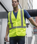 High Visibility Neon Safety Vest With Universal Fit ANSI ISEA Class 2 Lightweight Sweat Free Mesh worn by a person outdoors