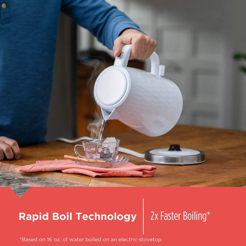 1.7L Cordless Electric Kettle With Rapid Boil, Auto Shutoff, And Water Window, Premium Textured Finish in White pouring water into a cup.