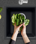 E-100 Midnite Quartztone Bar Sink Dual Mount 13x13 Inch Single Bowl Black with spinach being washed, top view
