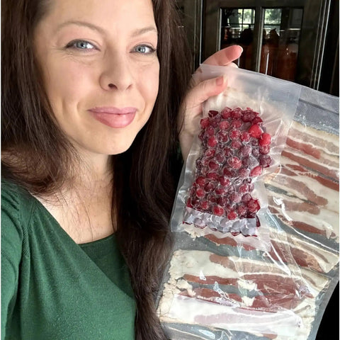 Woman holding sealed cranberries and bacon in 100 Count Pre Cut 4x6 Vacuum Sealer Bags 4 Mil Commercial Grade BPA Free