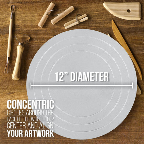 Front view: 12-inch sculpting wheel with all-metal turntable on a wooden work surface, surrounded by sculpting tools.