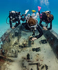 Divers using G2 Wrist Dive Computer And Transmitter Bundle With Hoseless Air Integration exploring underwater wreck.