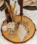 Ten 13-14 Inch Wood Slices For Go-To Centerpieces set with dried flowers, candle, and "reserved" note, rustic table decor.