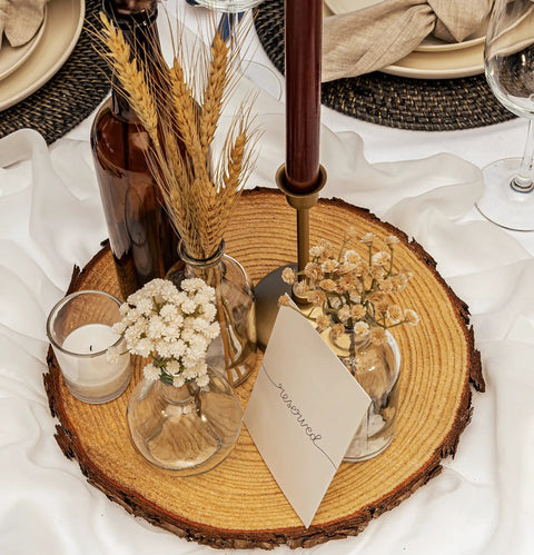 Ten 13-14 Inch Wood Slices For Go-To Centerpieces set with dried flowers, candle, and "reserved" note, rustic table decor.
