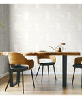 Dining room with Nikki Chu Zulu Signature Peel And Stick Vinyl Wallpaper Roll as wall covering, wooden table and chairs