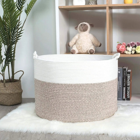 Extra Large 22x16 Inch Cotton Rope Storage Basket With Grab Handles A Rugged Yet Chic Woven Bin For Blankets Pillows Towels Laundry Toys Shoes And More Perfect For Easy Home Organization In Black Or Gray shown in a cozy room.