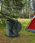 Pop Up 29.5 Gallon Outdoor Trash Can Collapsible for Parties, Yard Work, Camping, or Laundry next to a red tent in a forest