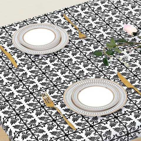 Snug Fit Elastic Fitted Vinyl Table Cover For 6 Foot Tables, Non Slip Waterproof Flannel Backed Plastic Tablecloth, Stain Proof, Ideal For Picnics, Camping, Outdoor Events, Black 30x72 Inches covers a table with plates and cutlery.