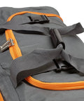 Close-up of 22 Inch Polyester Rolling Duffel Bag With Expandable Design, charcoal color, showing orange zippers and black handle straps.