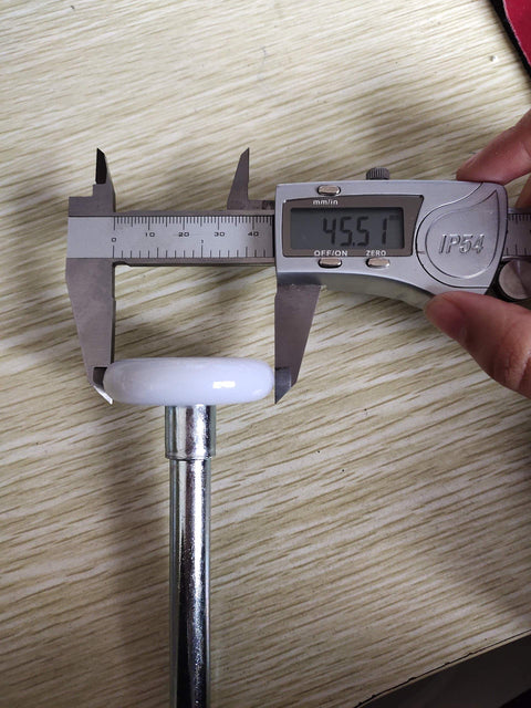 Measuring a Two Pack 2 Inch Nylon Garage Door Rollers With 11 Ball Bearings And 6.2 Inch Stem For 2 Inch Tracks with calipers