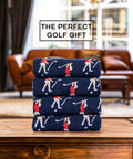 Stack of navy blue funny angry golfer socks for men size ten to thirteen, hilarious golf gift displayed on a wooden table.