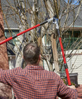 Man using Extendable Handles Compound Action Bypass Lopper For Thick Branches Up To One And A Half Inches with Dual Pivot Leverage