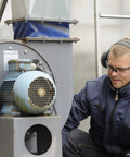 Top Shelf Heavy Duty Earmuffs Industrial Grade With Dielectric Wire Headband And Tilt Earcups worn by a worker at a motor.