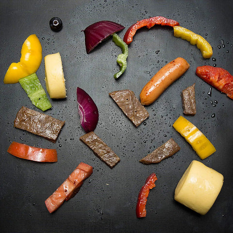 Heavy Duty Grill Mats Set Of 5 Nonstick BBQ Mats with assorted grilled vegetables and meats on a grill mat surface.
