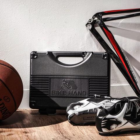 18 Piece Bike Repair Tool Kit Set With Torque Wrench For Mountain And Road Bikes in a black case, next to cycling gear.