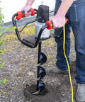 Man using 1500W Electric Post Hole Digger Earth Auger with 6 Inch Bit Set for fence posts installation in yard