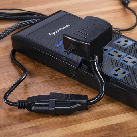 Six Inch Heavy Duty Extension Cord With Two Grounded Nema 5 15R Outlets and power strip on wooden surface