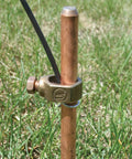 Insulated Electric Fence Wire 50 Ft 12.5 Gauge UGC50 connected to a copper ground rod in a grassy field
