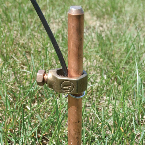 Insulated Electric Fence Wire 50 Ft 12.5 Gauge UGC50 connected to a copper ground rod in a grassy field