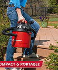 Pro Grade 2.5 Gallon Wet Dry Shop Vac Featuring Wall Mount Storage And Killer Suction Motor For Rapid Garage Sweeps Durable Carry Handle Design In Fiery Red being carried on stairs.