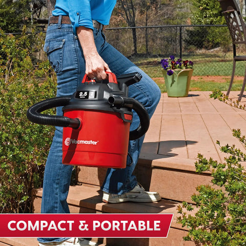 Pro Grade 2.5 Gallon Wet Dry Shop Vac Featuring Wall Mount Storage And Killer Suction Motor For Rapid Garage Sweeps Durable Carry Handle Design In Fiery Red being carried on stairs.