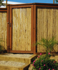 Natural Bamboo Fence Roll Panel 0.75 Inch Thick 6 Foot High By 8 Foot Long used as garden fence with tropical vibe.