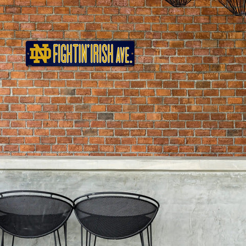 Notre Dame Fighting Irish 16 Inch Plastic Street Sign Wall Decor on brick wall, perfect for college football fan gear.