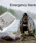 Person using emergency blanket from 10 In 1 Emergency Survival Kit With Knife, Blanket, Compass, Fire Starter, Flashlight, Saw, And More Waterproof Case Built For Beast Mode Camping, Hiking, Hunting, And Outdoor Adventure