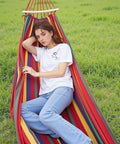 Person relaxing in Ultra Lightweight Portable Camping Hammock For Backpacking Beach Patio And Backyard Durable Fabric Easy Setup Packs Small