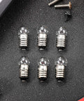 50 Pack E10 Miniature Screw Base Light Bulbs 3.8 Volt 0.3 Amp Mini Pilot Lamps arranged on a textured black surface.