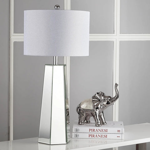 Janice Modern Art Deco Mirror Chrome 32 Inch Table Lamp Set Of 2 With Off White Cotton Shade displayed beside books and silver elephant sculpture