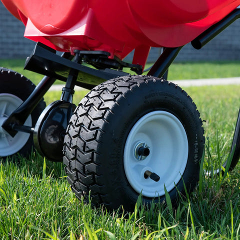 Close-up of wheels on Big 80lb Capacity Broadcast Spreader For Lawns And Seeds With Rustproof Poly Hopper Pre Assembled