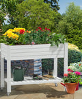 Elevated Garden Bed Kit With Legs And Wheels Large Resin Planter Box Stand With Drain Plug And Storage Shelf Perfect For Plants Vegetables Fruits Outdoor Durable Grayish White in garden setting with plants