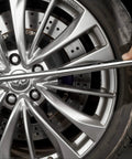 Using Telescoping Lug Wrench With 1/2 Inch Drive And 17mm 19mm 21mm 22mm Sockets on a car tire for easy maintenance.