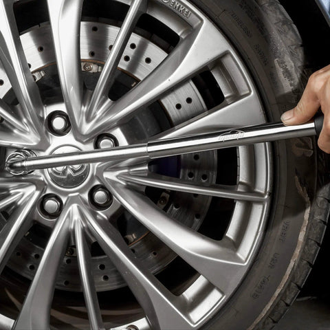 Using Telescoping Lug Wrench With 1/2 Inch Drive And 17mm 19mm 21mm 22mm Sockets on a car tire for easy maintenance.