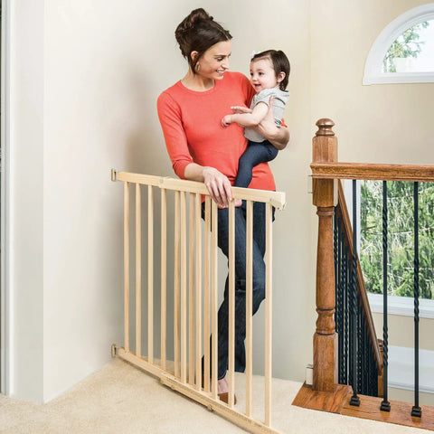Walk-Through Top Of Stairs Baby Gate In Natural Wood With Four Point Mount, One Hand Release, Dual-Direction Swing, Installed At Stairs