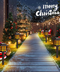 Outdoor Solar Torch Lights 10 Pack With Dope Flickering Flame illuminating a snowy garden path with Christmas decor